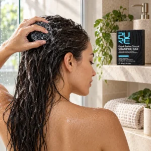 Woman washing wet hair with PURC Bamboo Charcoal Shampoo Bar in a bright bathroom