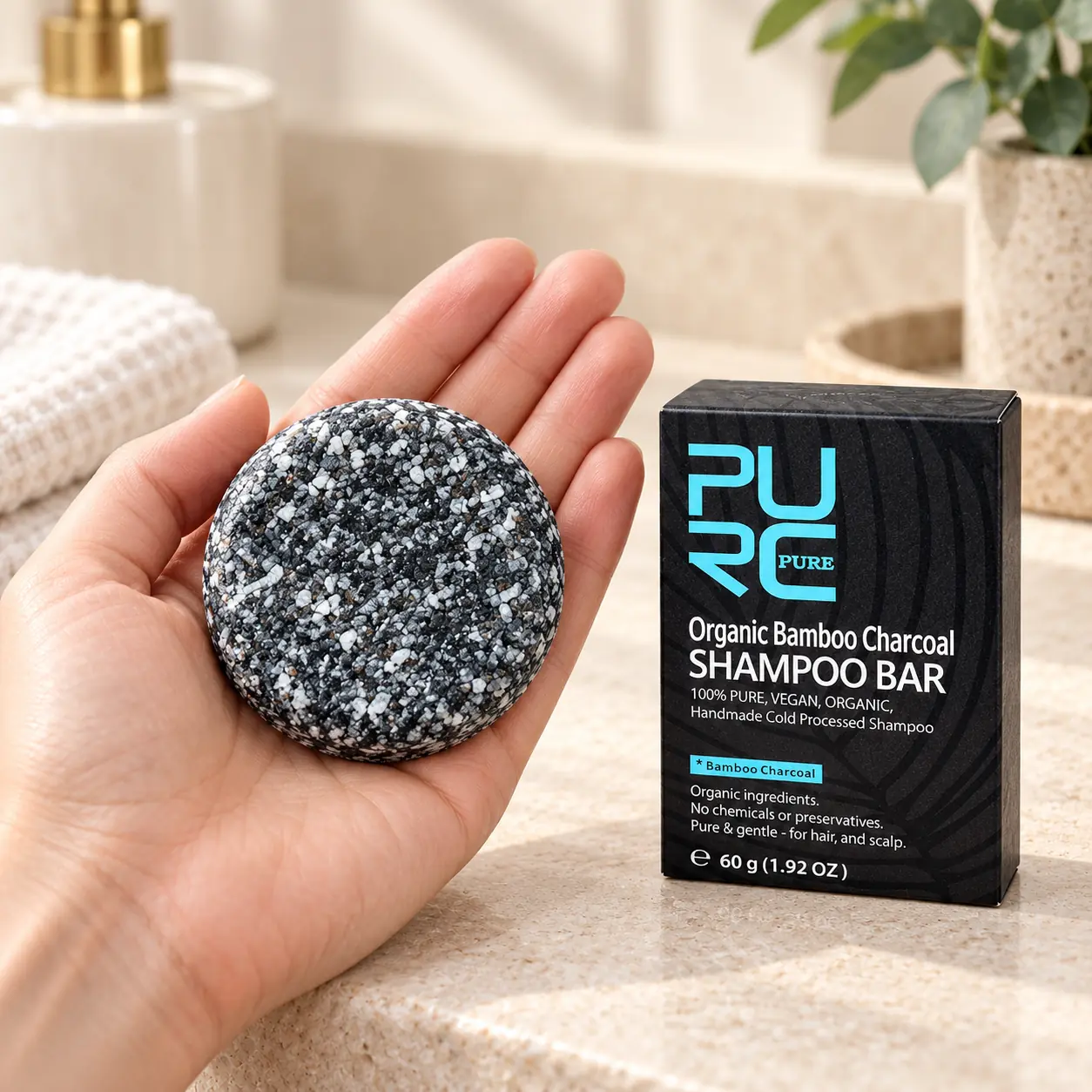PURC Bamboo Charcoal Shampoo Bar shown in hand for 60g size reference