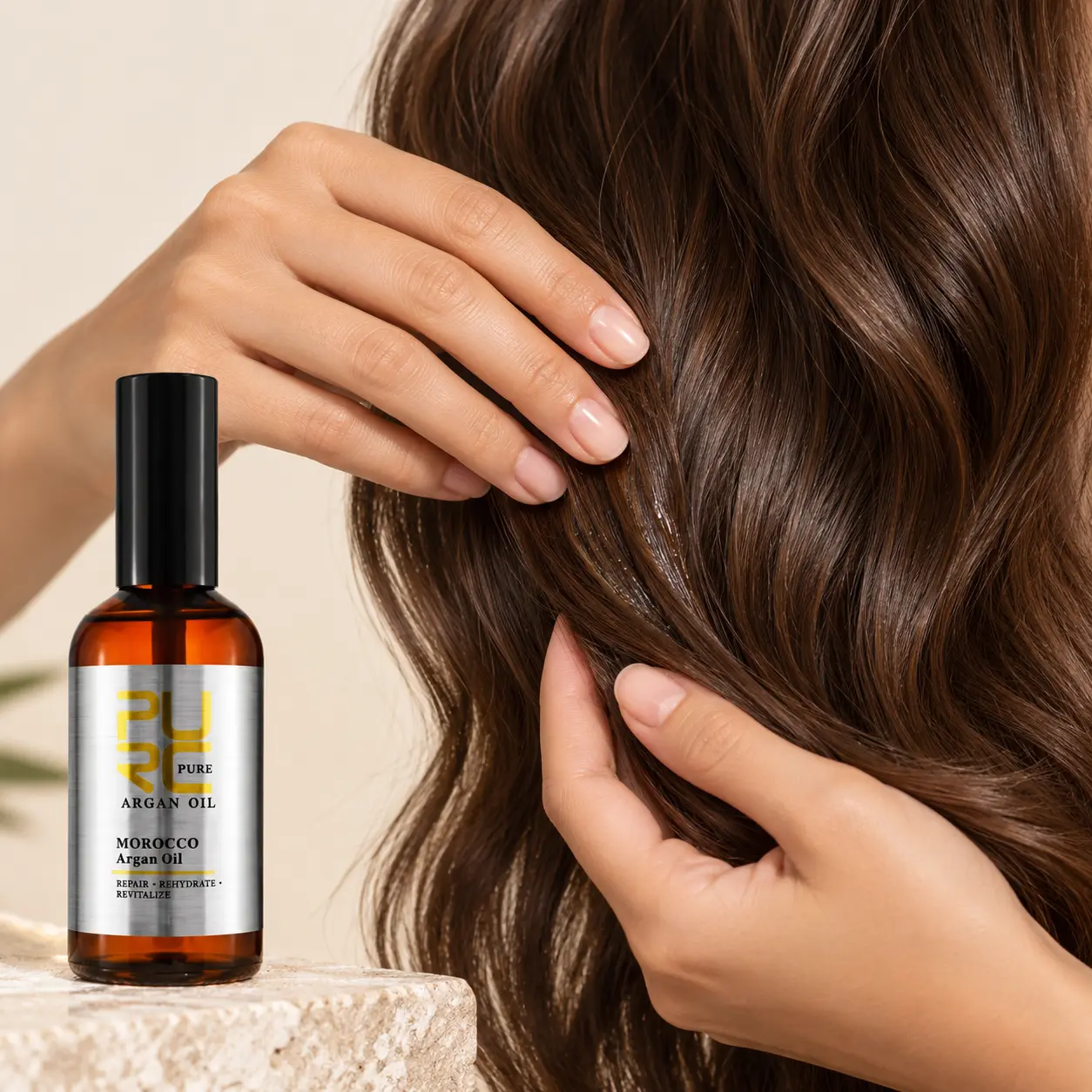 PURC Moroccan Argan Hair Oil beside a hand smoothing oil through wavy hair lengths