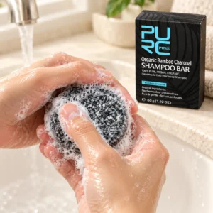 PURC Bamboo Charcoal Shampoo Bar creating a creamy lather between wet hands