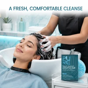 Stylist massaging lather into wet hair beside PURC Bio Seaweed Shampoo Bar