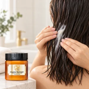 Hands applying PURC Magical Treatment Hair Mask to wet hair lengths with jar in foreground